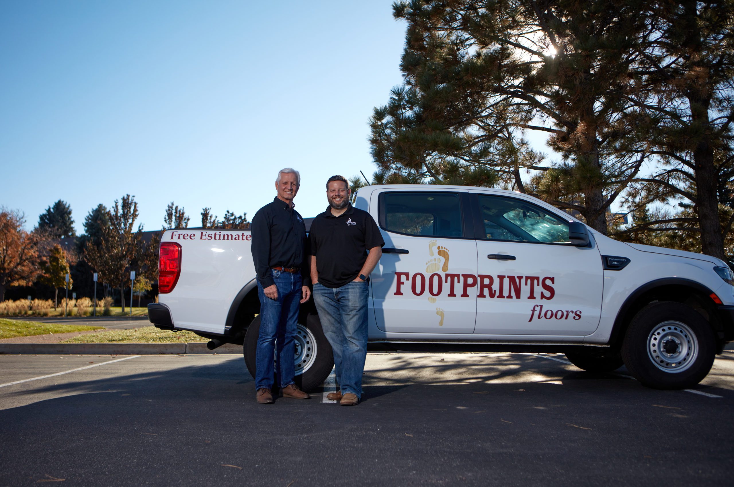 footprints floors franchise owners in front of truck